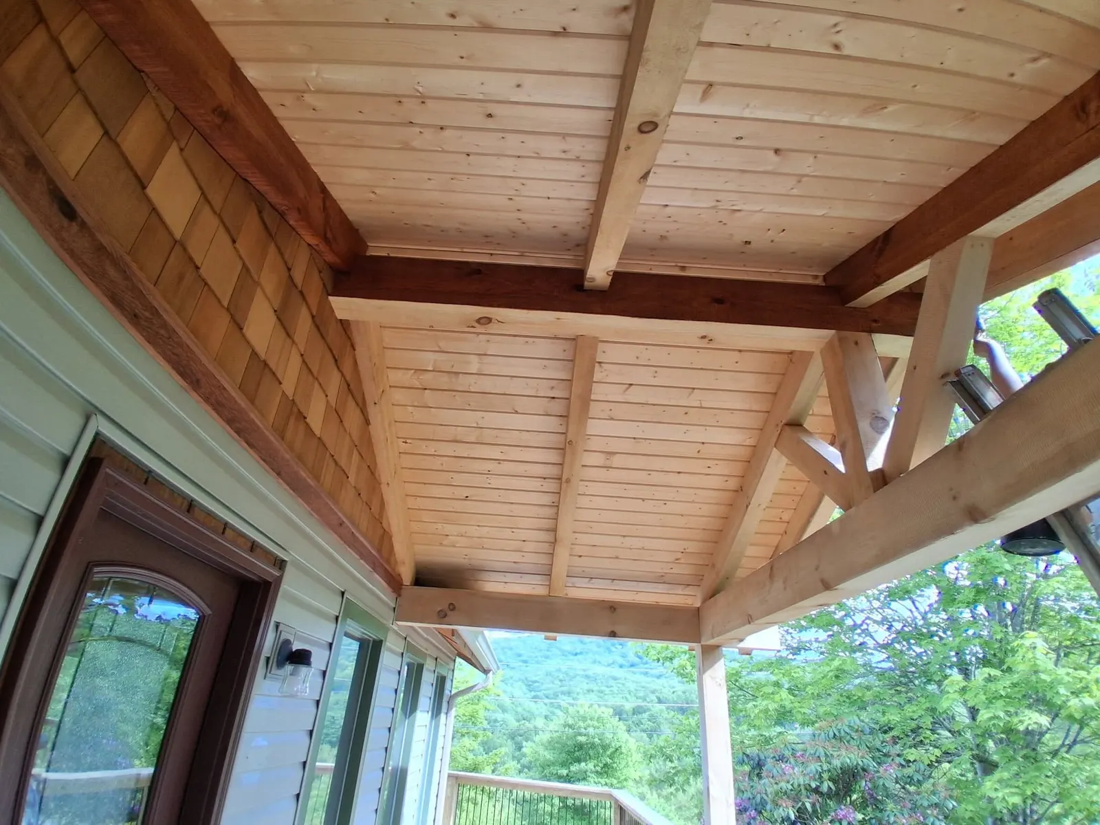 Natural wood porch ceiling before staining on a new construction home