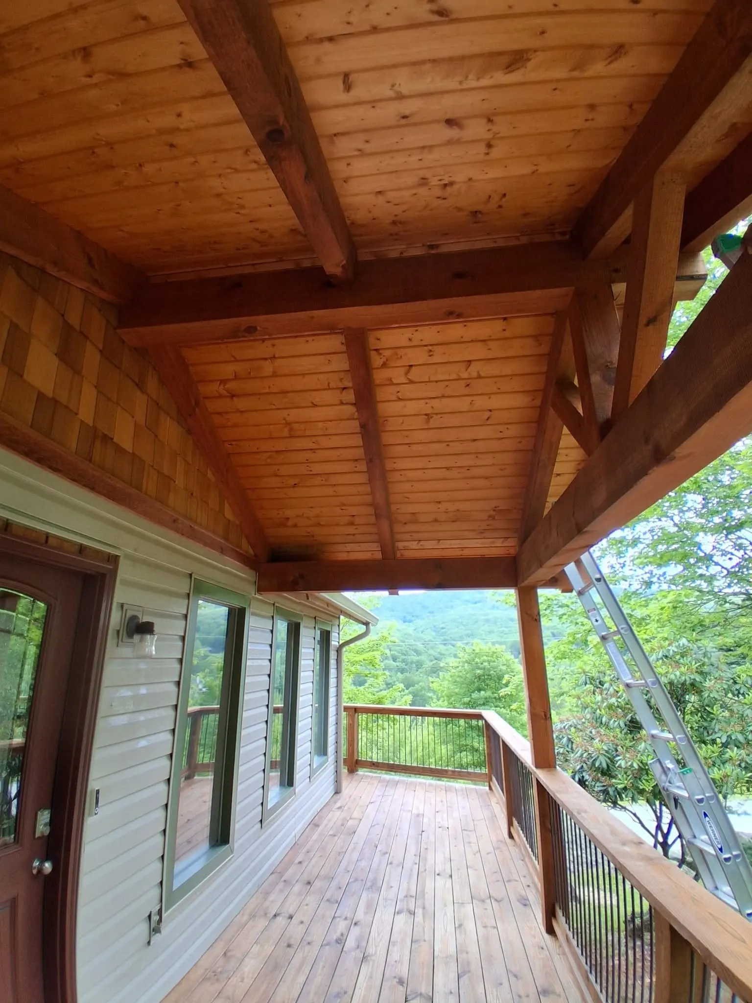New unstained covered porch before staining on a mountain home