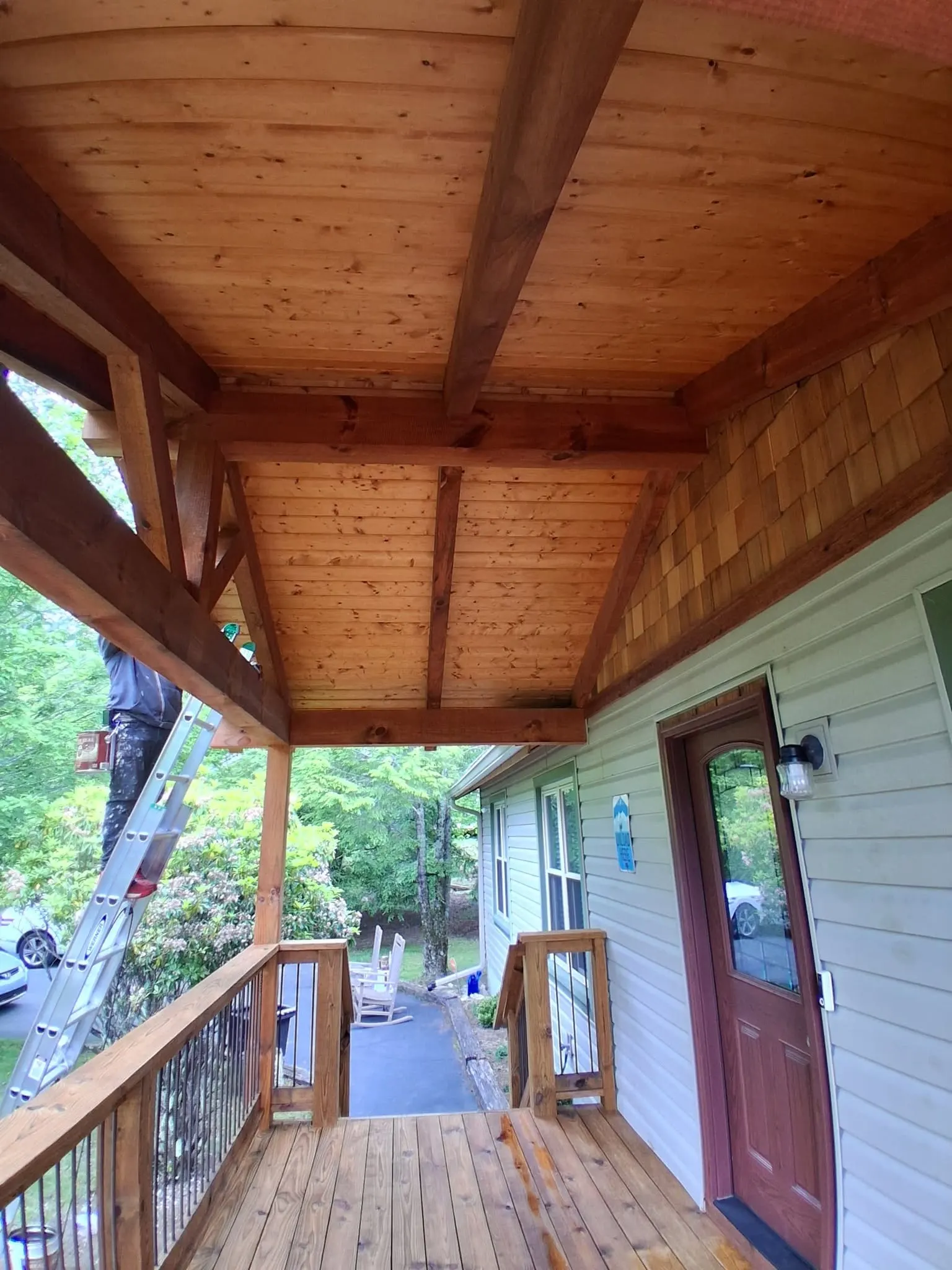 Ramirez Custom Painting crew member staining a deck beam near Swannanoa NC