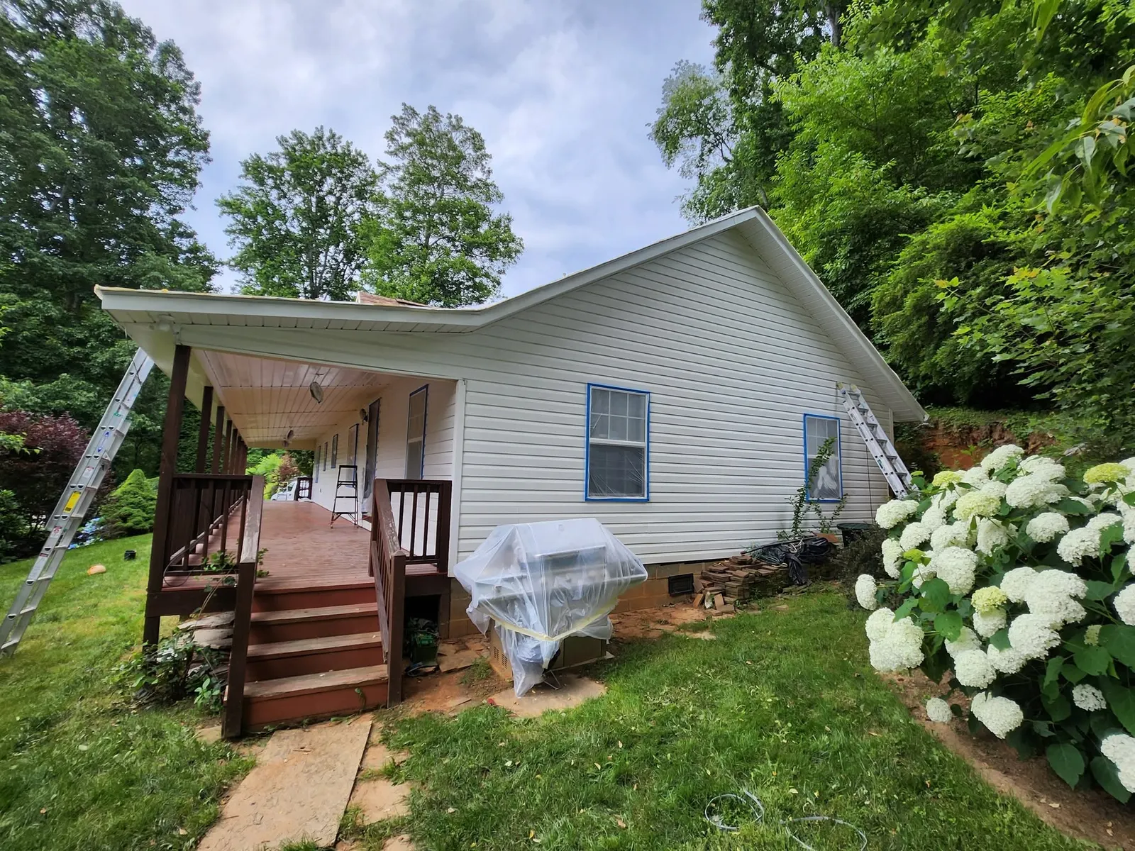 Exterior painting prep with masked windows on a home near Swannanoa NC