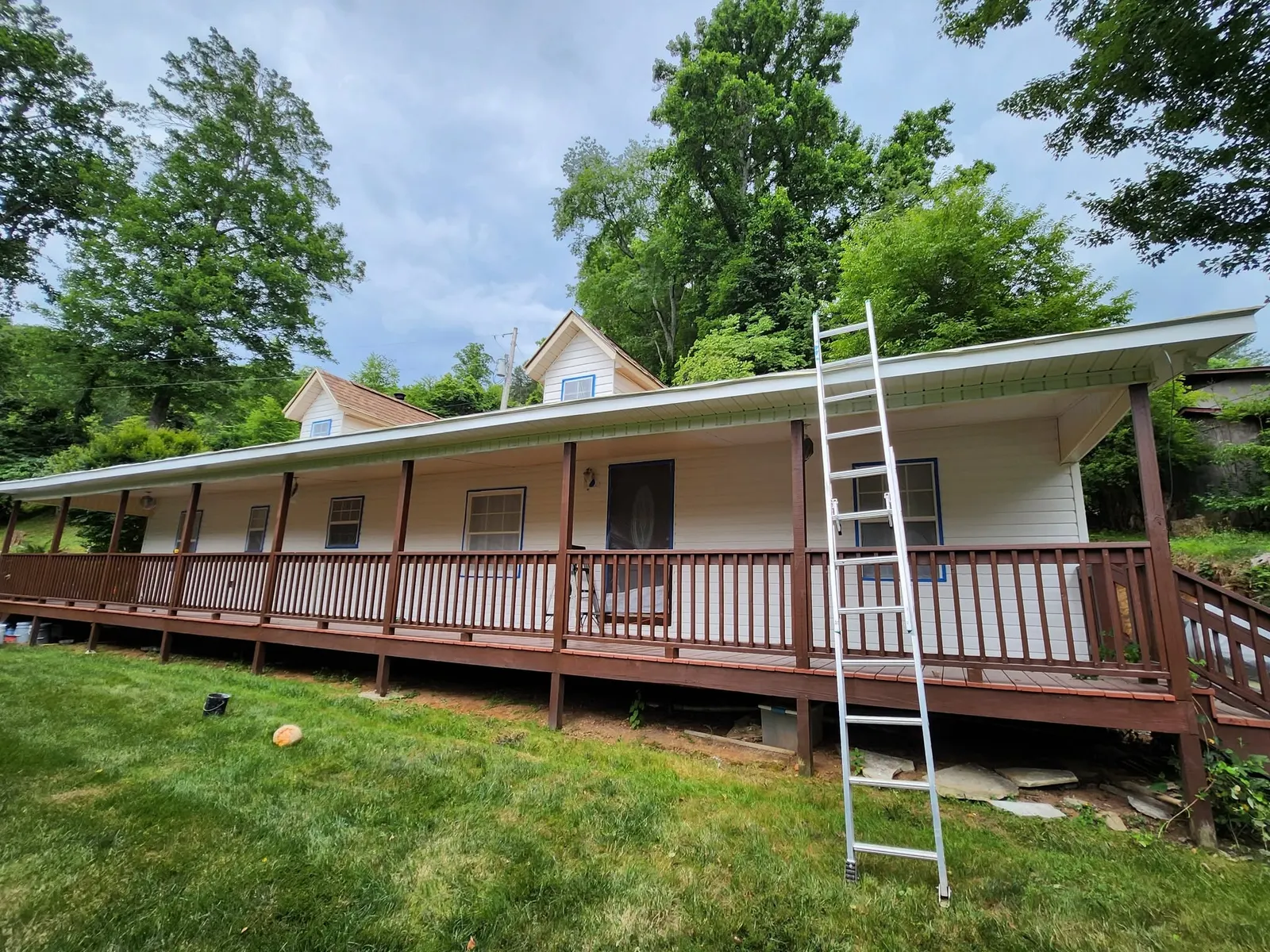 Exterior painting prep with masked windows on a home near Swannanoa NC